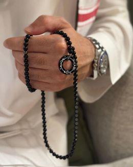 مِن معدَن الإنسَان سبحة إِنَّا لِلّهِ وَإِنَّـا إِلَيْهِ رَاجِعونَ مطلية بالروديوم - عقيق أسود